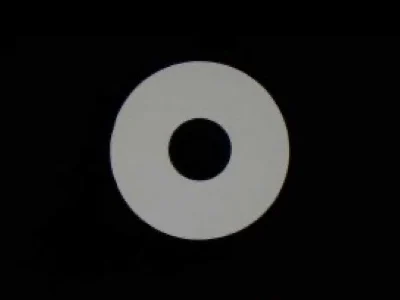 Microscope image of a pick-up nozzle's round tip face with its vacuum hole.