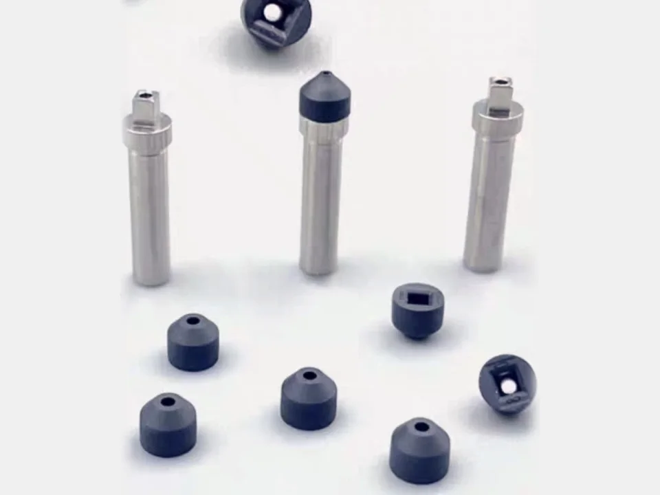 Dark rubber pick-up nozzle tips beside the steel shanks they fit on.